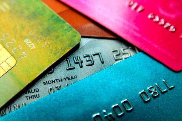 Stack of multicoloured credit cards close-up view with selective focus.