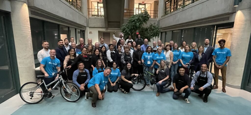 Serenia Life employees and advisors posing for a group shot after bike-building event