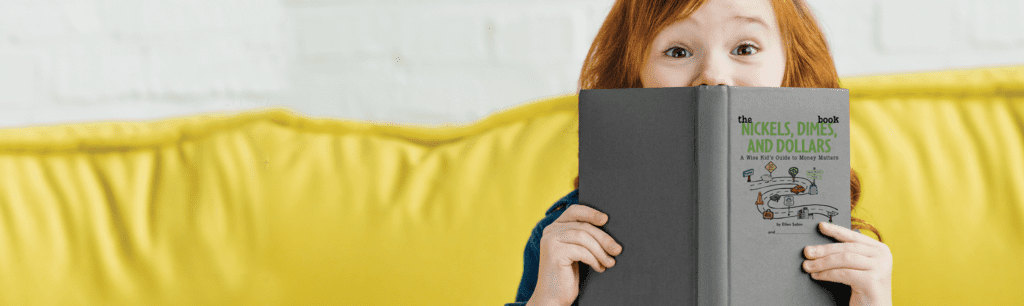 Little girl reading financial literacy book