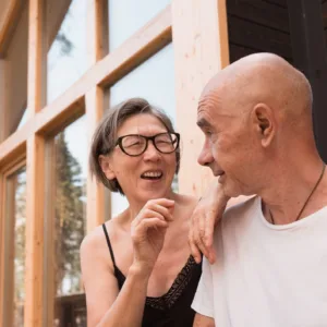 Senior couple, laughing and chatting at the cottage